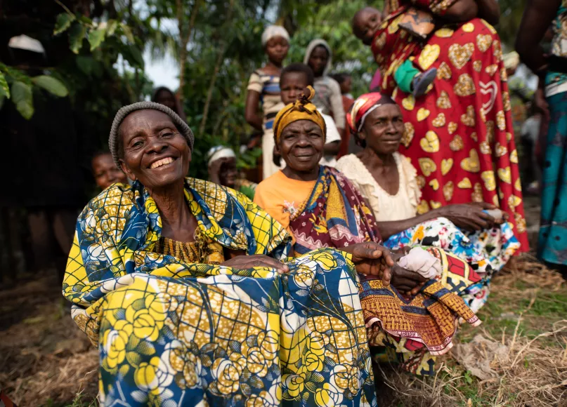 Three women smile at the camera in DRC. Miguel Samper, 2009 Mercy Corps.