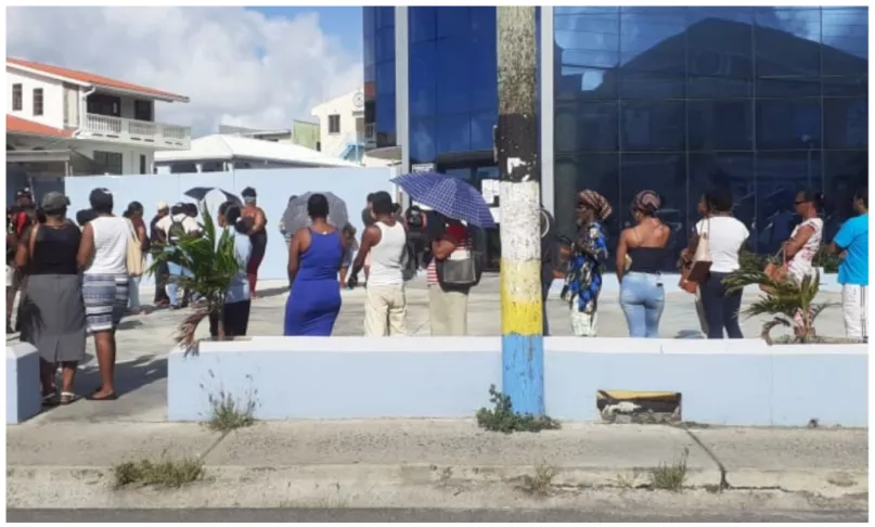Members line up outside a credit union on March 27, 2020 in St. Lucia. Photo credit, St. Lucia Times. 