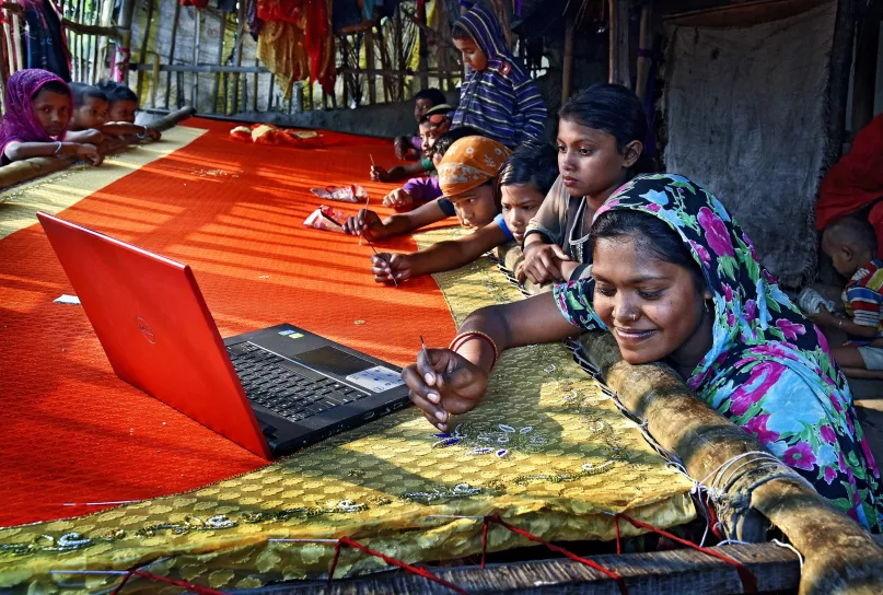 Women knitting sarees, India.