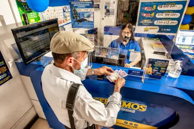 A man conducting a transaction at a counter.