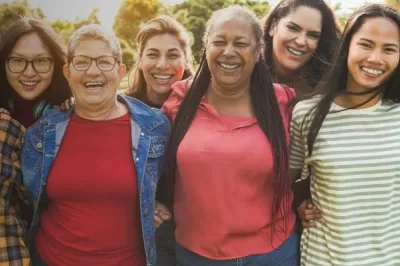 Group of six women smiling at the camera.