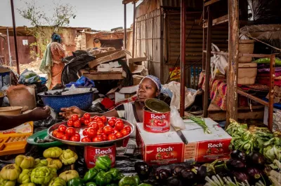 Woman selling tomatoes in market in Burkina Faso.