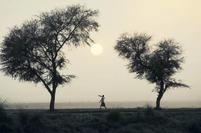 A person walking in the distance in the dusk.