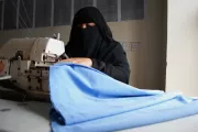 Woman using sewing machine, Yemen.