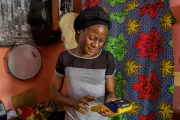 A woman in Nigeria uses a mobile money machine