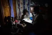 Using solar-powered light from a pay-as-you-go kit, Mali. Photo by Communication for Development Ltd.