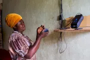 Woman uses a solar powered radio