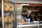 Woman with an apron and hair net in a bakery