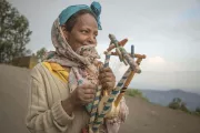 Woman in Ethiopia plays string instrument.
