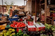 Woman selling tomatoes in market in Burkina Faso.