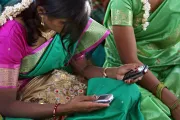 Community meeting. Girl on cellphone. Aurangabad, India. Photo credit: Simone D. McCourtie / World Bank