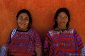 Two women posing for a photo in traditional clothing, Guatemala.
